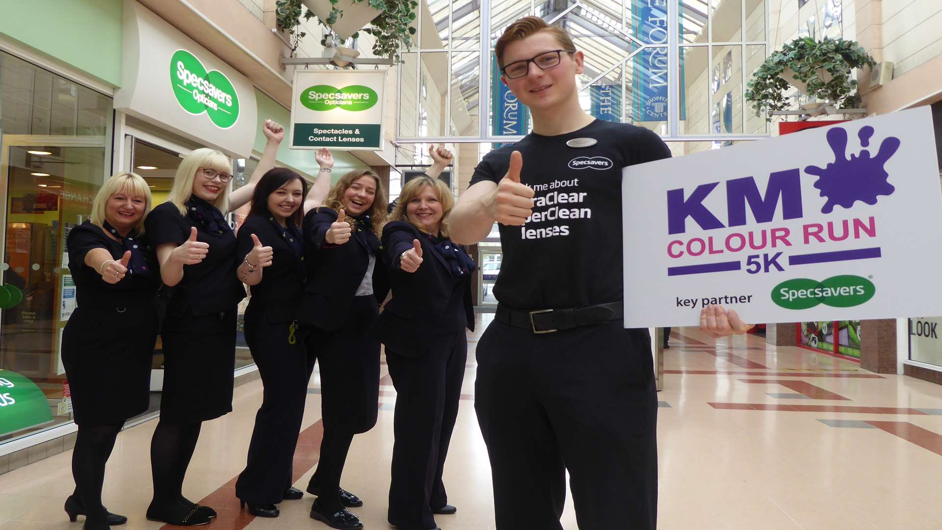Chris Walker and Specsavers staff in Sittingbourne encourage shoppers to sign up for the KM Colour Run.