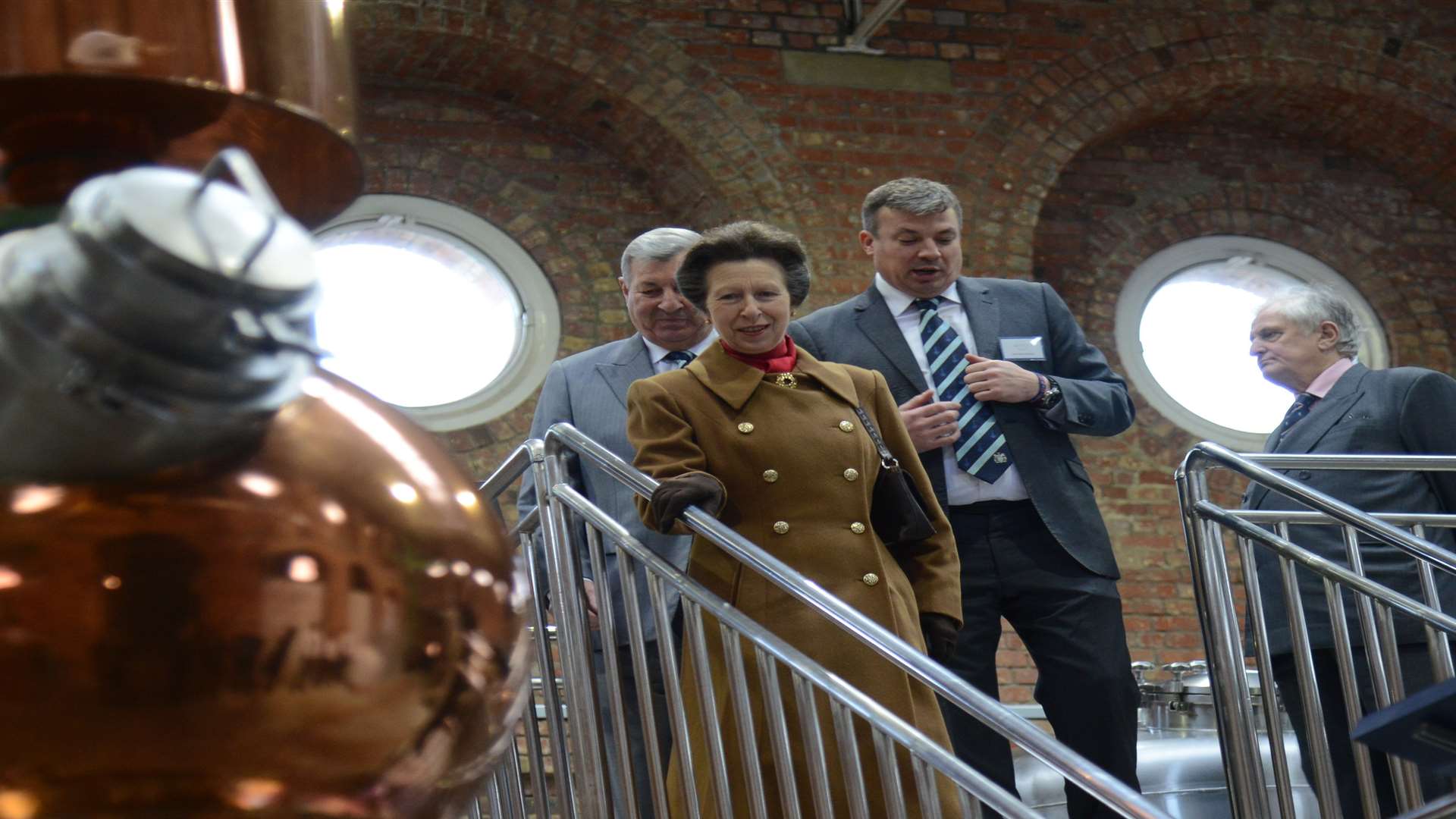 Matthew and Bob Russel showing Her Royal Highness around the distillery.