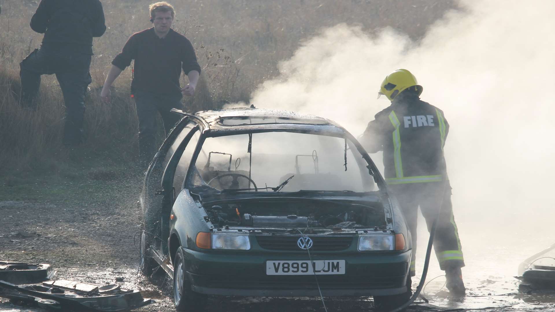A fireman tackles the blaze after a car was blown up in Leysdown for the new TV series Kiss Me First