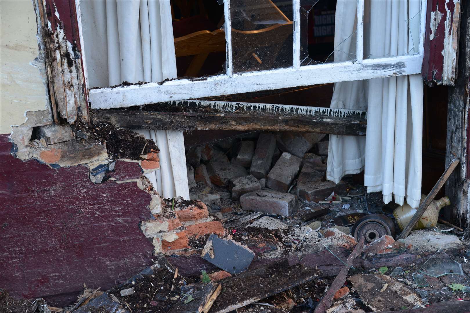 A close-up showing the scale of the damage from a car that struck the Cinque Port Arms in New Romney.