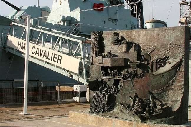 HMS Cavalier and the bronze monument at Chatham's Historic Dockyard by it forms the National Destroyer memorial. Copyright: Gail James