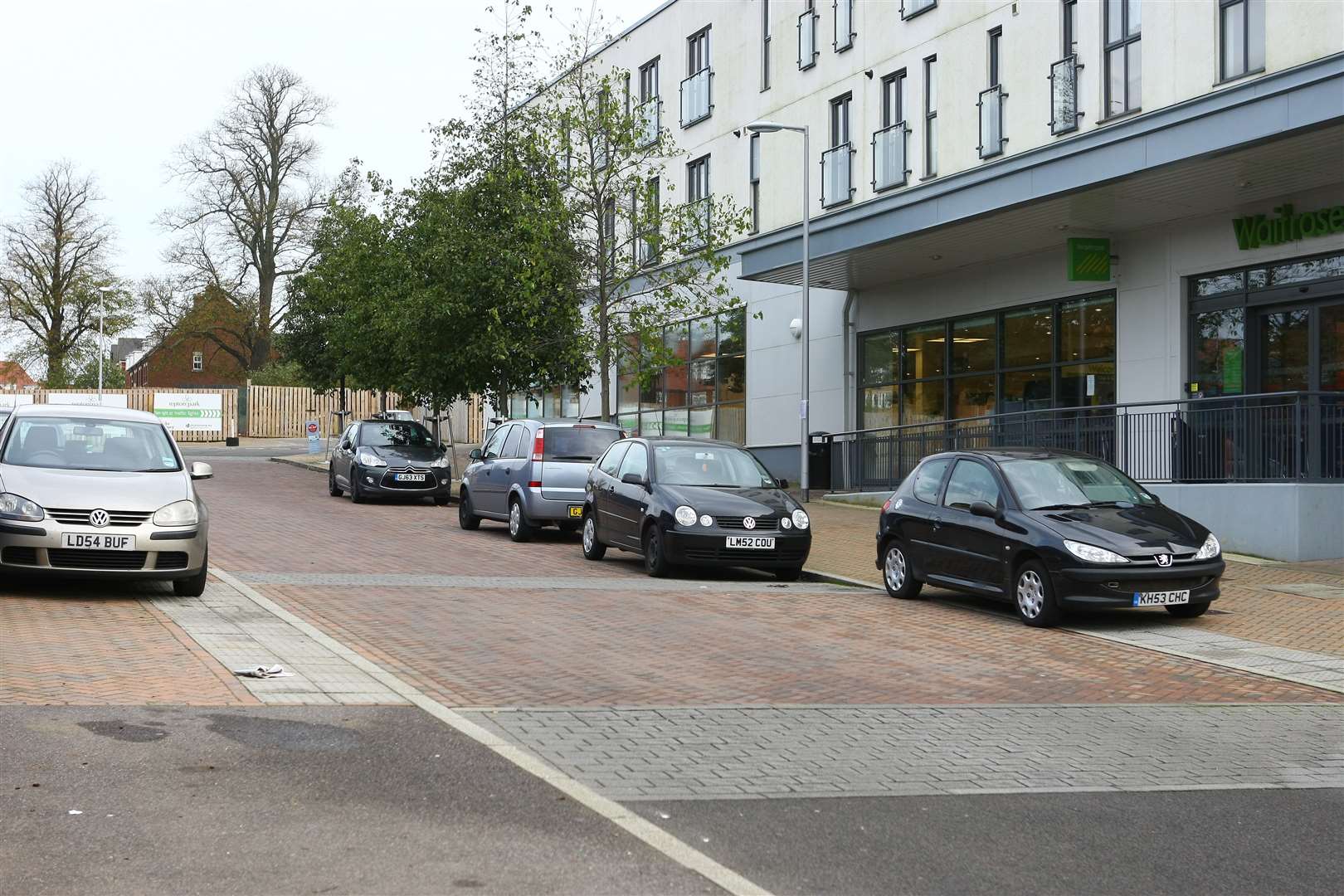 THEN - cars parked either side of the approach road to the Waitrose supermarket car park