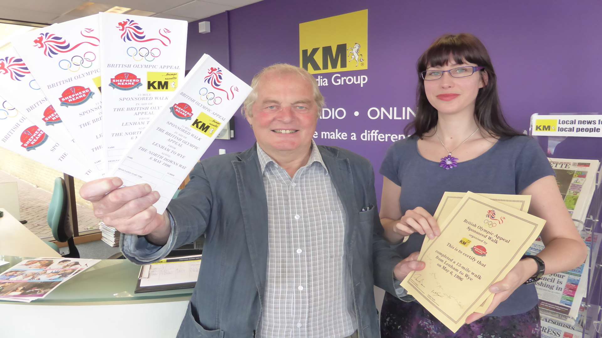 Peter Andrews, organiser of the first KM Charity Walk 20 years ago, visits the KM offices with flyers and certificates from the original event.
