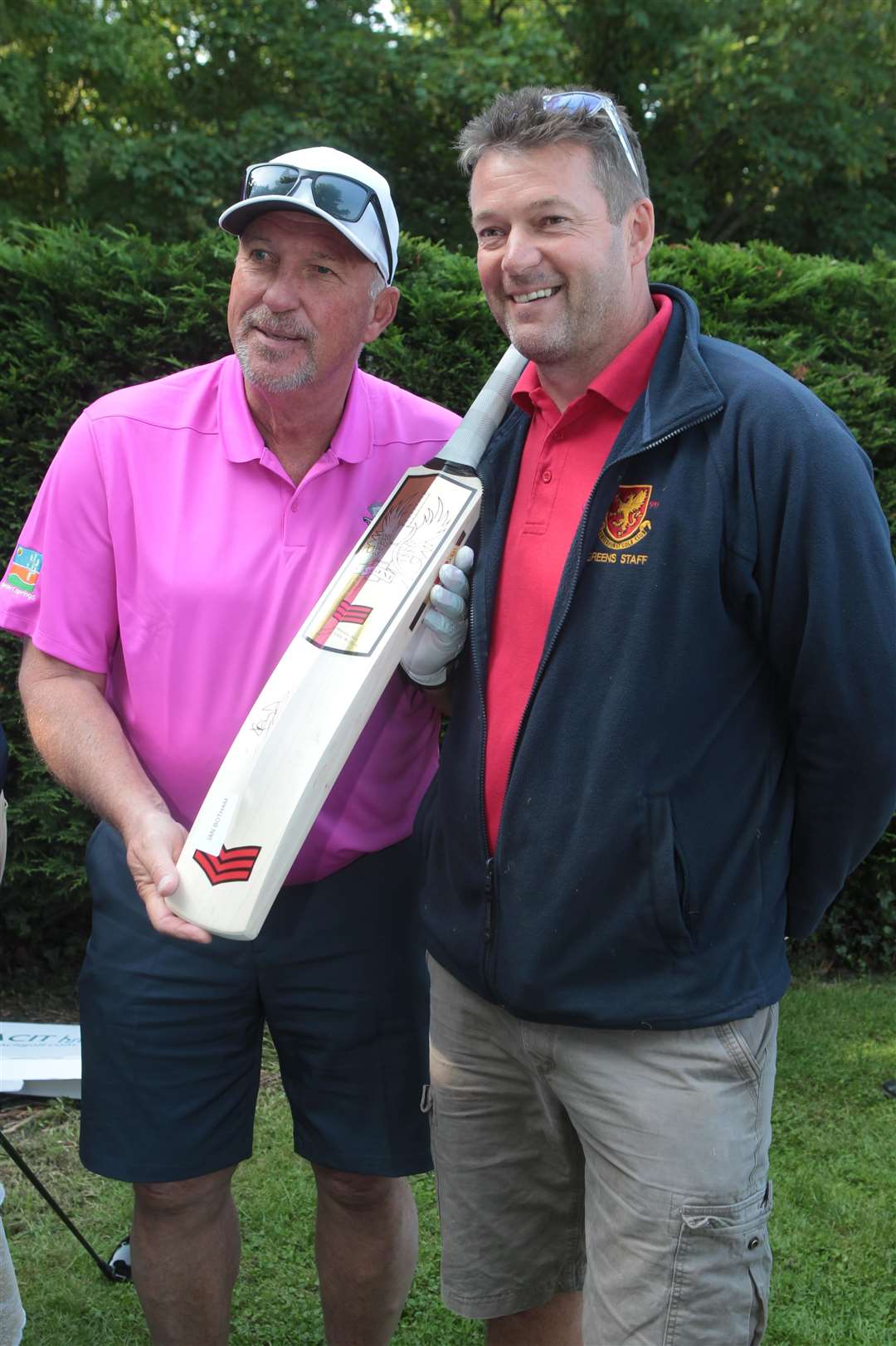 Ian Botham with a signed cricket bat that Gary Sargent, standing with him, made at Lamberhurst Golf course where Botham and Johnston were flown in to play one round of golf at the 18th hole to raise money for charity. Picture by: John Westhrop (2422768)