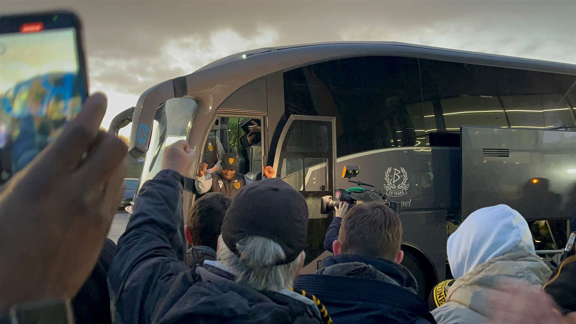 Maidstone boss George Elokobi gets a rousing reception as the team bus arrives at the CBS Arena.