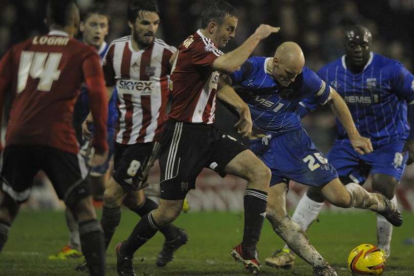 Captain Adam Barrett in the thick of the action against Brentford on Friday. Picture: Barry Goodwin