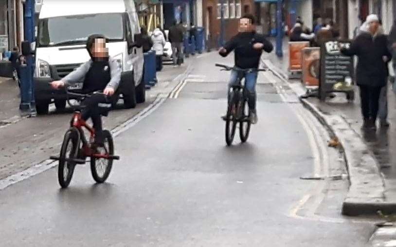Boy cyclists riding without hands through Sheerness (9147432)