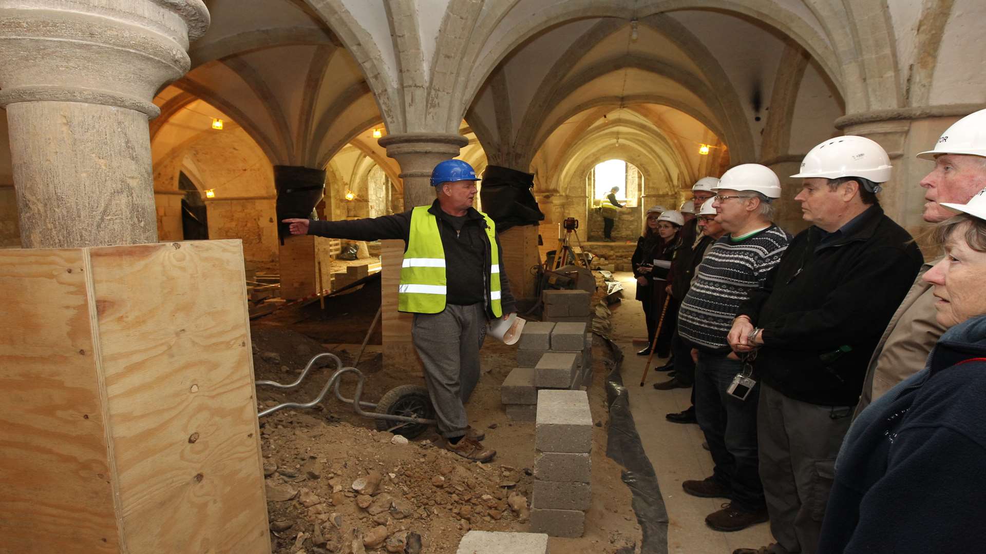 Graham Keevill, Cathedral Archaeologist talks to a group of people on a tour of the crypts of Rochester cathedral showing a Roman floor.