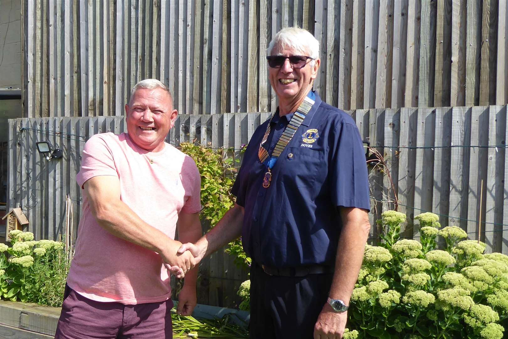 Outgoing president Garry Dixon hands over to Len Button. Picture: Dover Lions Club