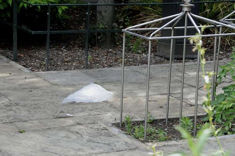 A plastic bag covers evidence in Canterbury's Dane John Gardens
