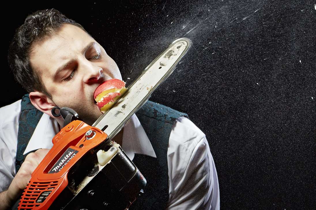 Johnny Strange is well-known for bizarre stunts, including chainsawing an apple in his mouth. Picture: Paul Michael Hughes/Guinness World Records
