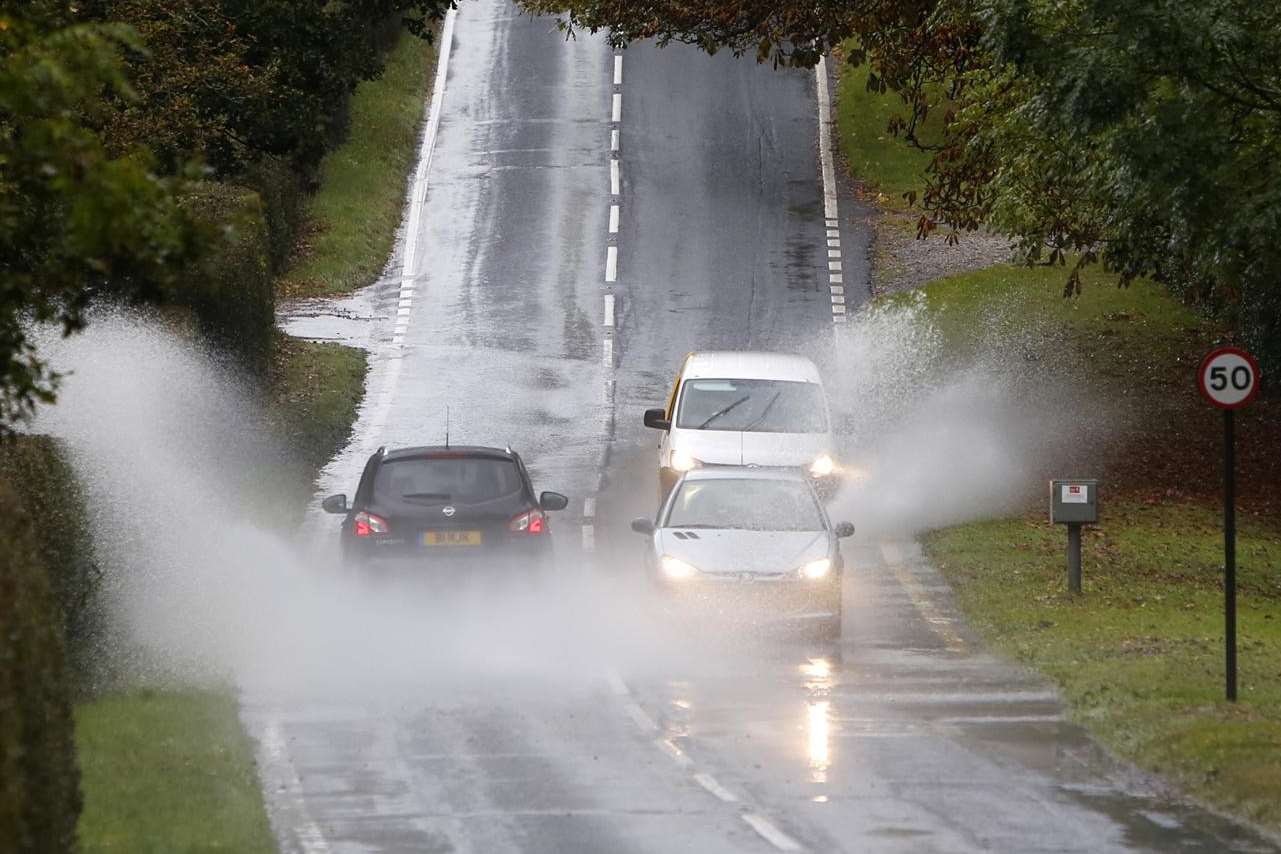 Drivers wade through surface water on the A227 at Shipbourne,