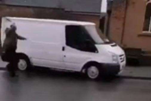 One man is seen chasing the van with what looks like a belt