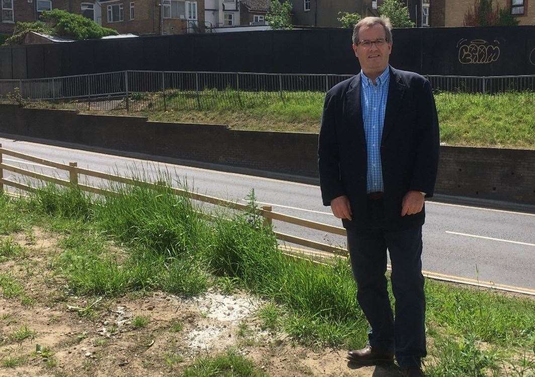 Developer Paul Helliwell with the black hoardings in Station Street, Sittingbourne, he wants brightened up