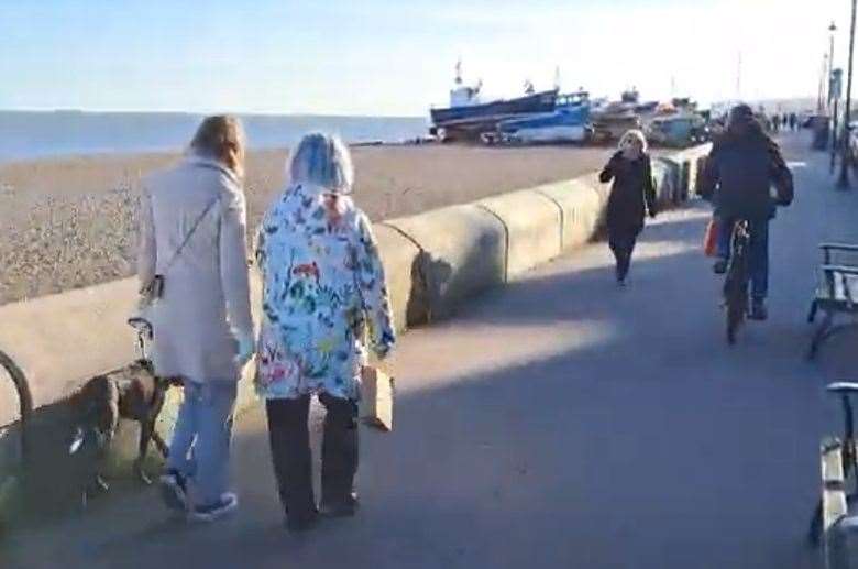 A cyclist passes pedestrians on Deal seafront's shared space