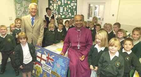 HAPPY DAY: The Rt Rev Michael Nazir-Ali with retired architect Ted Lane and some of the pupils. Picture JOHN WARDLEY