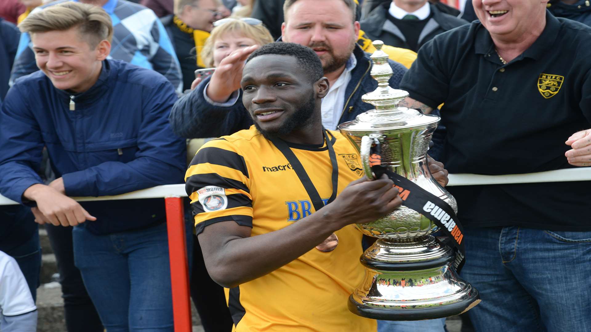 Manny Parry with the National South play-off trophy Picture: Gary Browne