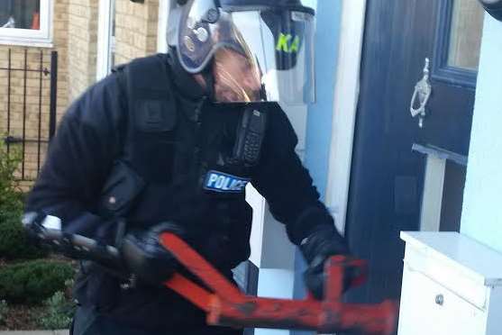 Police forcing entry to a property during a drug raid. Library image.
