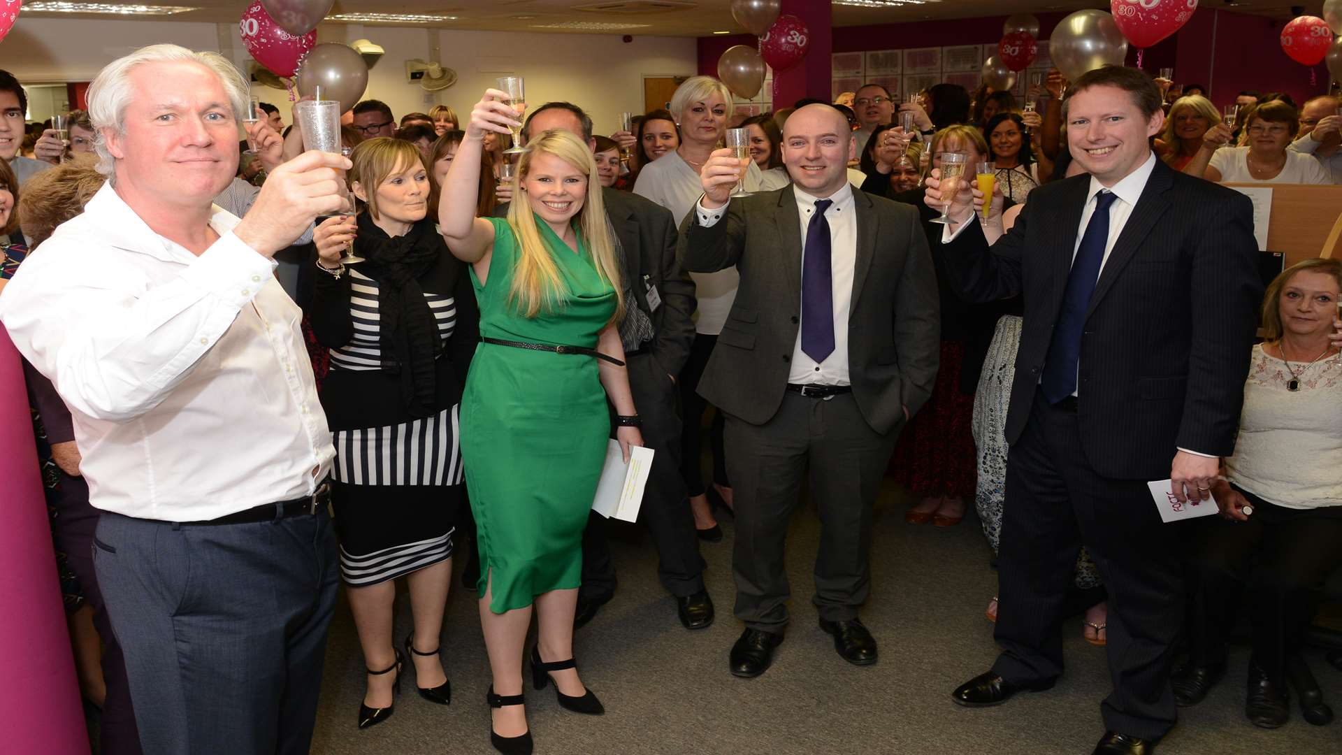Staff at Facts International toast the firm's 30th anniversary