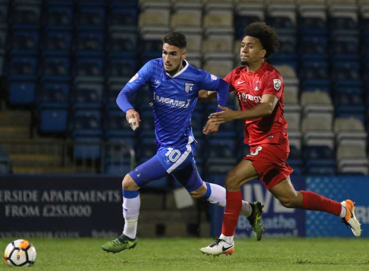 Gills' Conor Wilkinson is pulled back by Orient's Joe Widdowson, who collected his second yellow card. Picture: Andy Jones