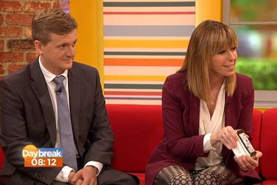Daybreak presenter Kate Garraway, pictured with co-host Aled Jones, presents Ella Birchenough with a new iPhone. Picture: ITV/Daybreak