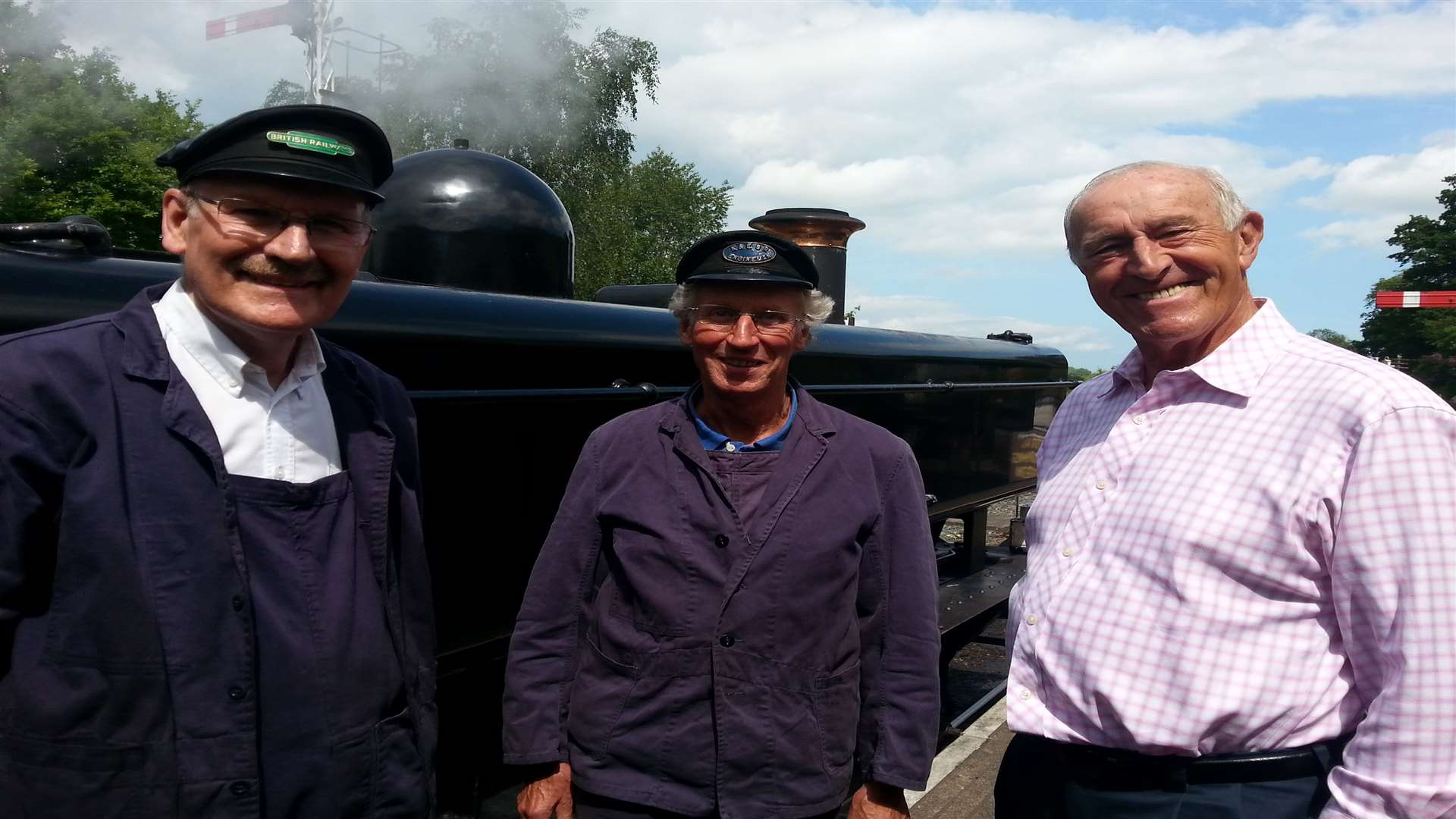 Fireman Tom White and driver Tom Featherstone chat with Len Goodman at the Kent & East Sussex Railway .Picture: Chris Davey.