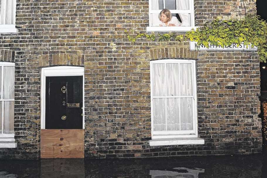 A worried householder surveys the scene on the corner of Knightrider Street in Sandwich. Picture: Tony Flashman