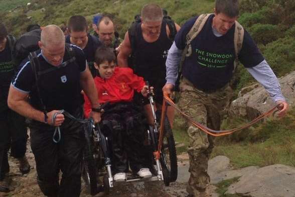Jake had a little help during the ascent of Snowdon from family and police officers