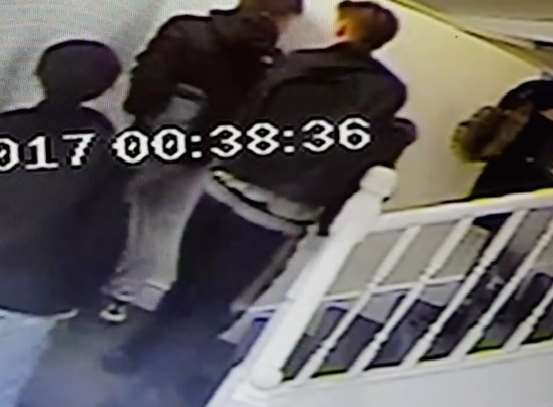 Vandals watch as one urinates on the staircase carpet