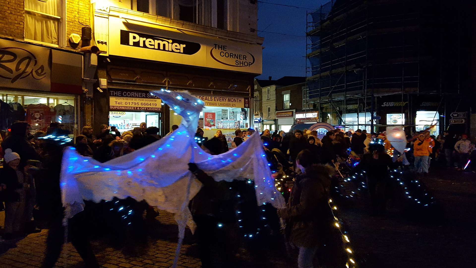 The lantern parade winds itself around the clocktower heading down the Broadway from High Street