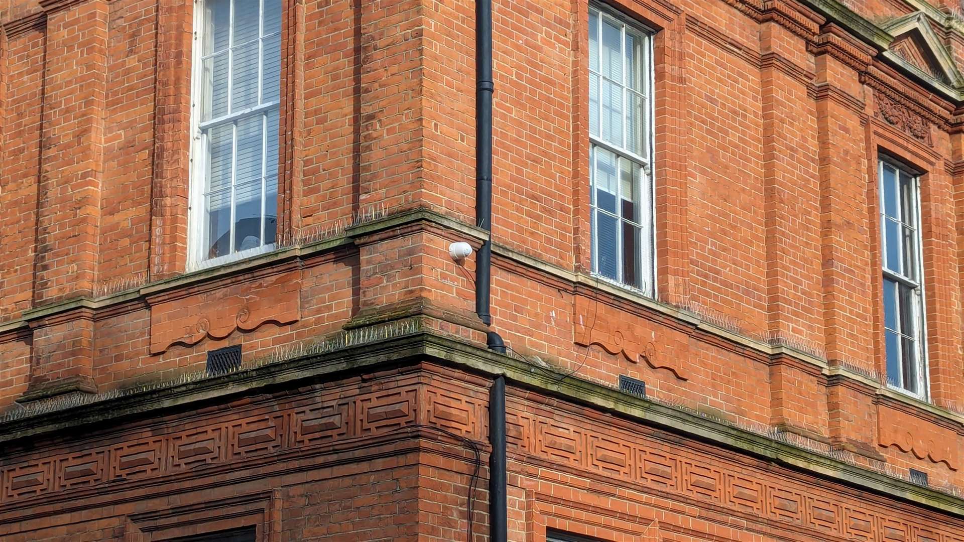 Historic England is calling for the CCTV cameras to be painted to match the colour of the building
