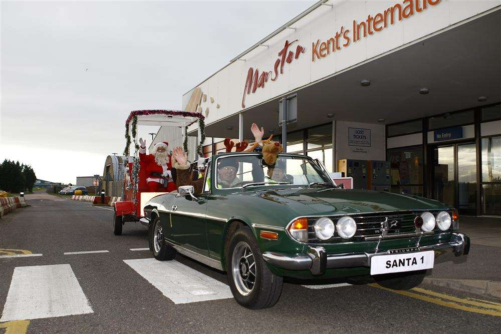 Father Christmas adopts a novel new approach to travel - arriving at Manston Airport to climb aboard a sleigh borrowed from the Rotary Club of Margate and pulled by a stag - only this time it is a Triumph Stag, rather than a reindeer.