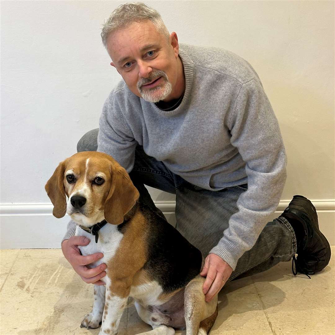 Brian Flynn with Flash the Beagle at home in Faversham, Kent. Picture: SWNS