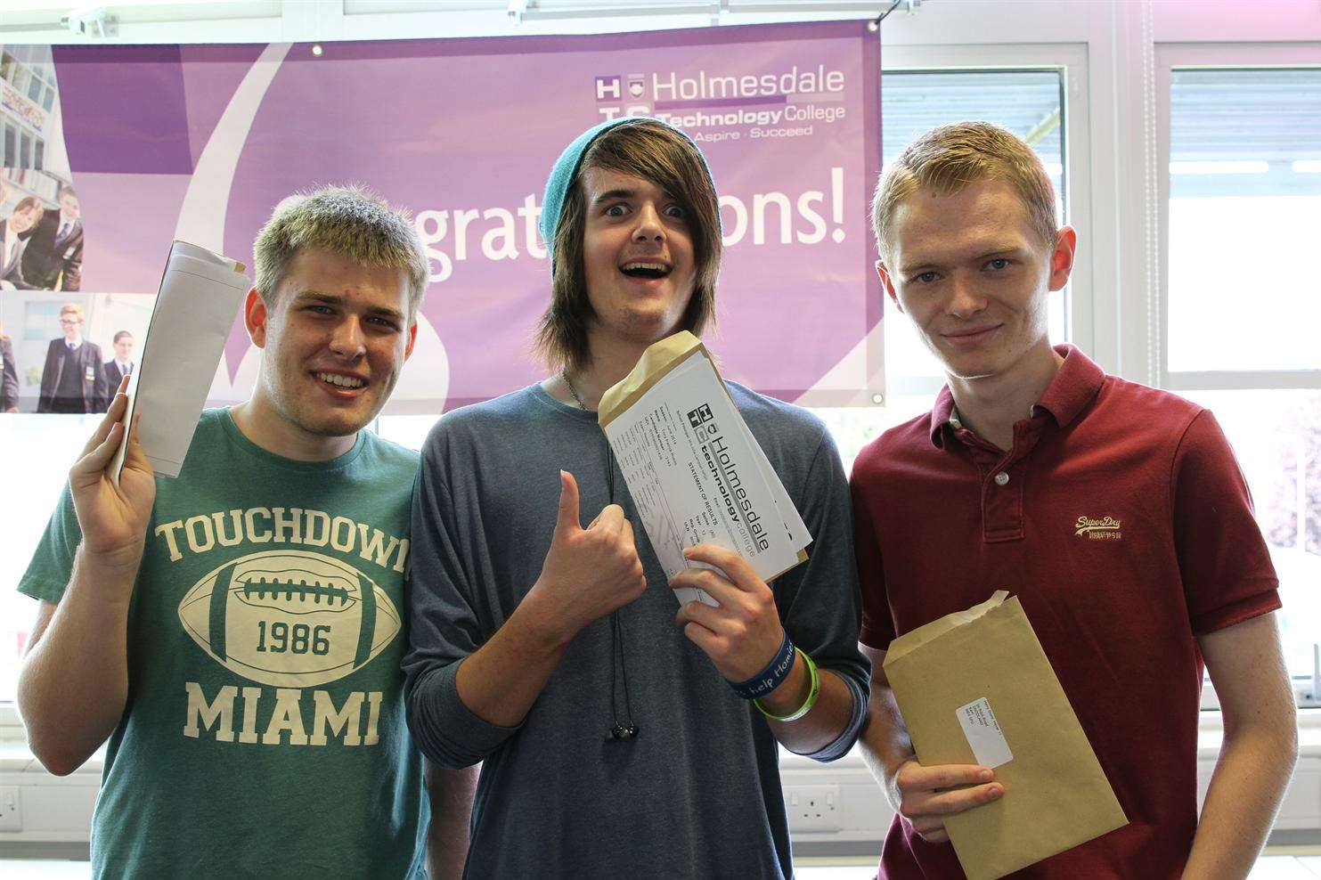 Lewis Boniface, Tony Russo and Harry Stone celebrate getting their A-level results at Holmesdale Technology College in Snodland.