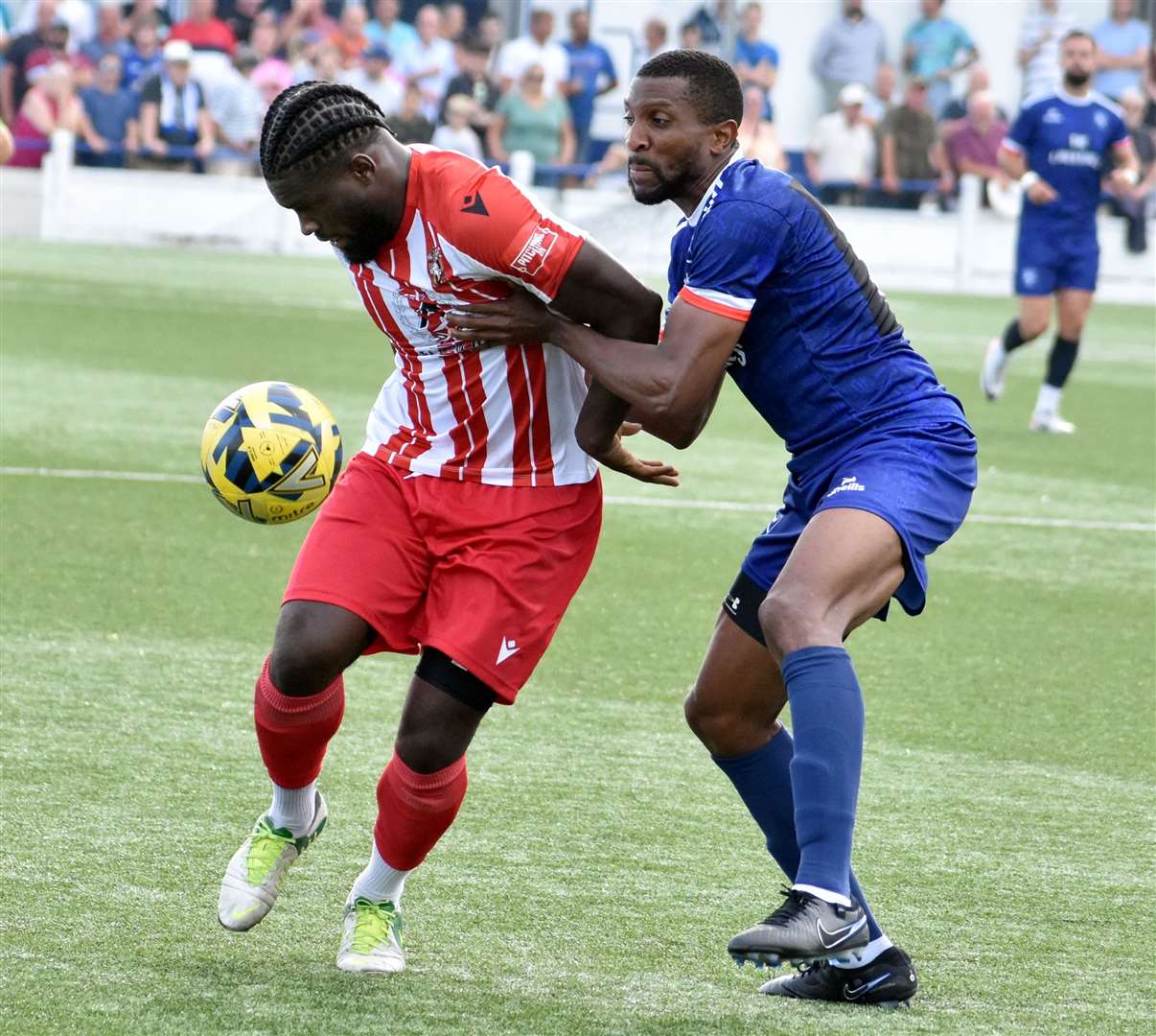 Tyrone Sterling of Margate gets to grips with Folkestone striker David Smith on Saturday. Picture: Randolph File