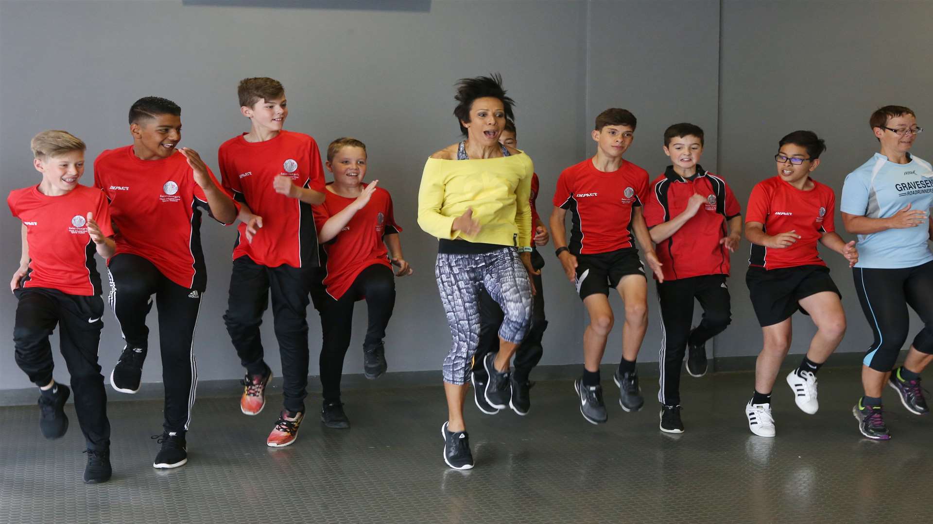 Dame Kelly leads an exercise session with her guests, including pupils from Saint George's School. Picture: John Westhrop