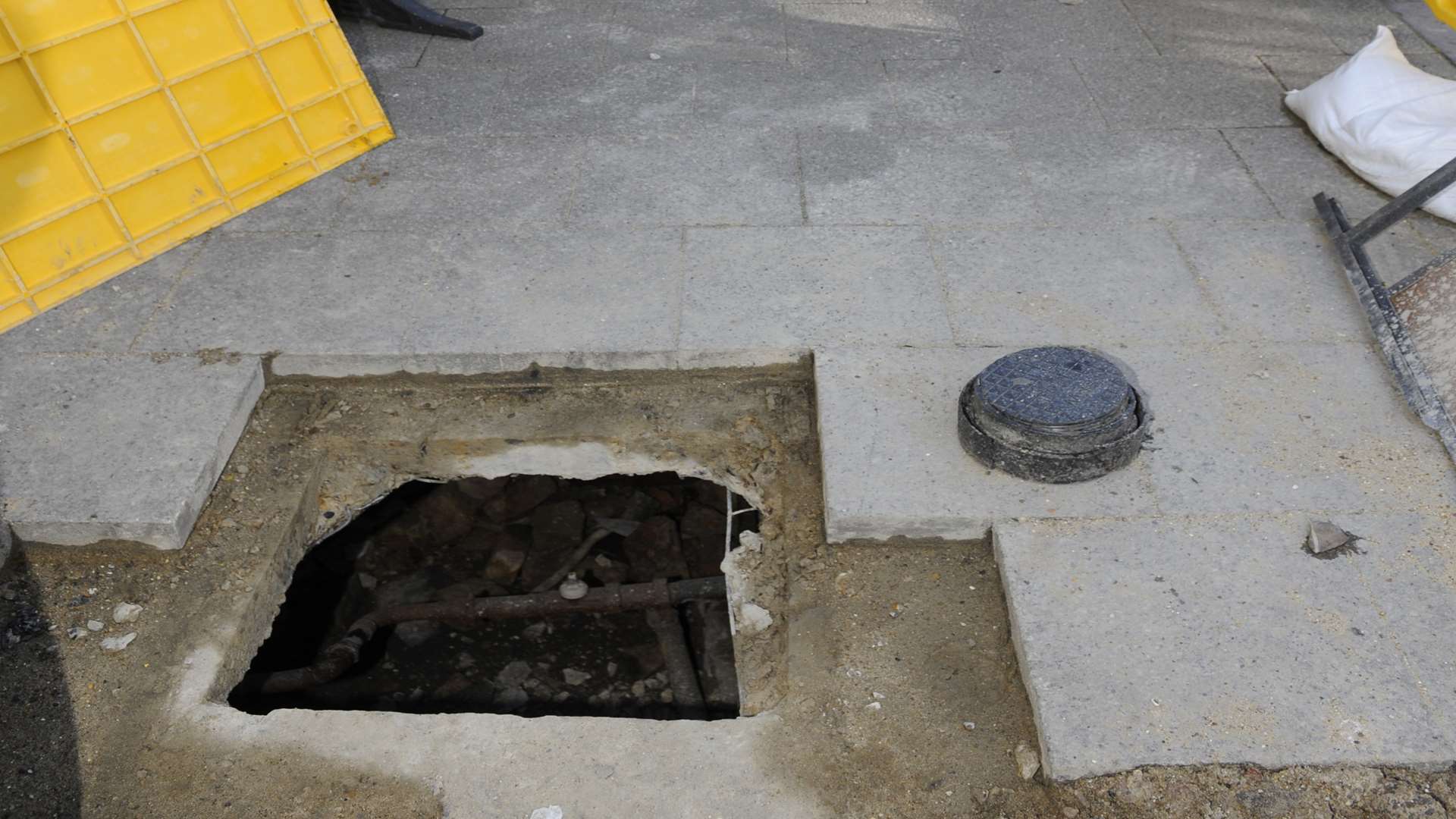 A huge hole can be seen in the pavement