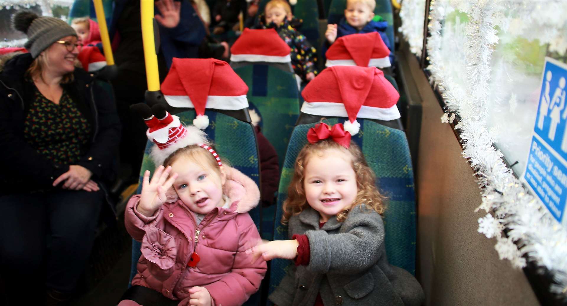 Two little passengers having a lovely time on the Frozen bus. Picture: Phil Lee