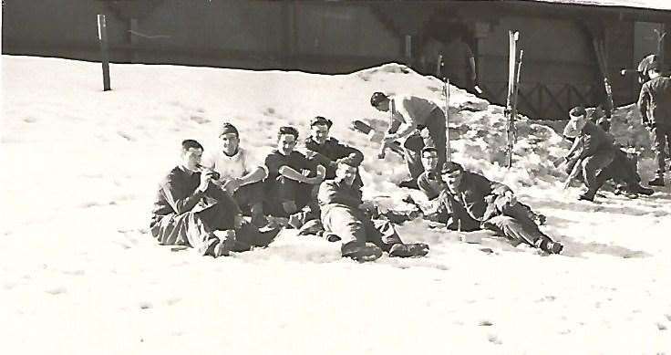 John Marsh and comrades sip ice cold beer lying on the snow in the Harz Mountains