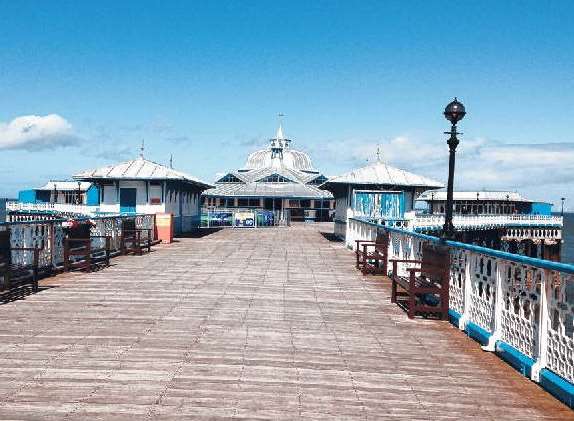 Llandudno pier has souvenir shops along the way to a well-positioned bar at the end