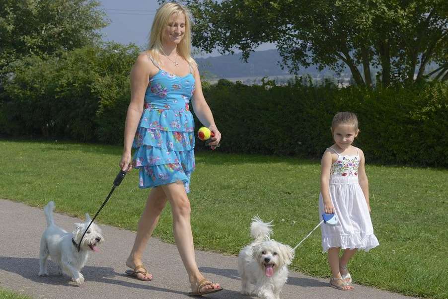 Elenea Osbourne, 4, and mum Carley Benson, walking dogs Daisy and Toby in the September sunshine