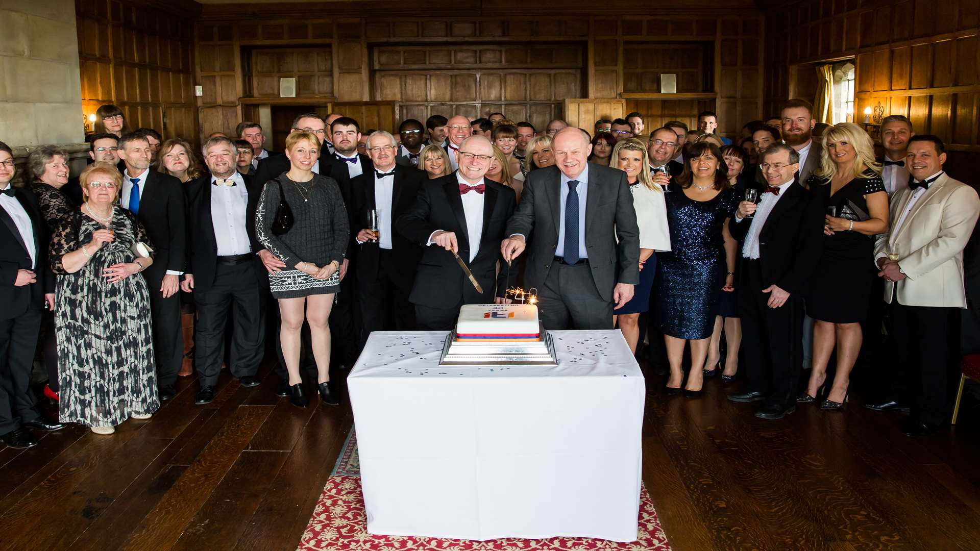 ITL chief executive Tom Cole, left, cuts the firm's 40th birthday cake with Ashford MP Damian Green at Lympne Castle