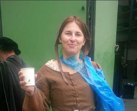 A cuppa keeps Nadine Lawson warm and the plastic kagool keeps her peasant costume dry on the set of Wolf Hall