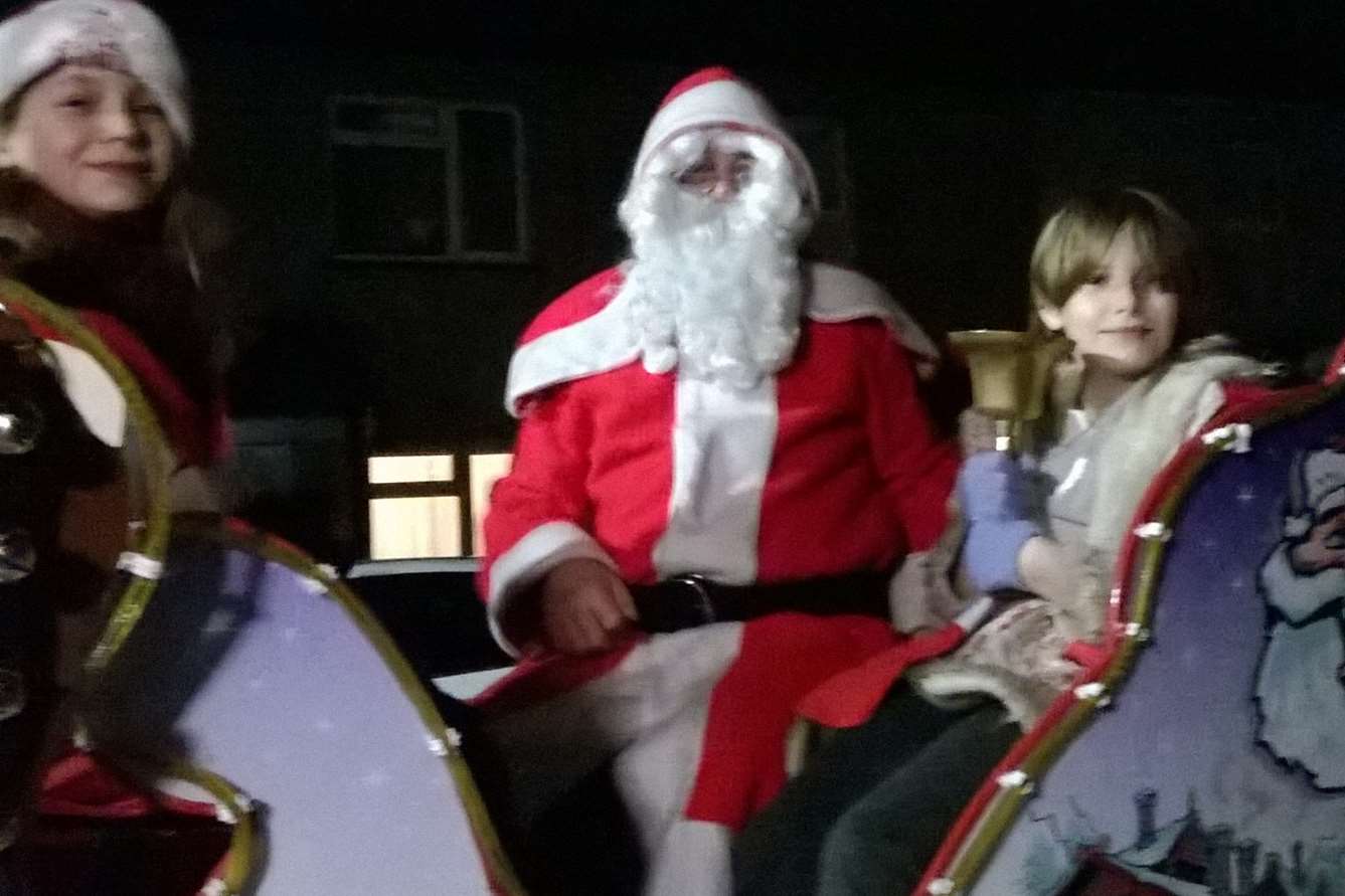 Santa with Megan Anca, 11, and Aiah Smith, 10, on the sleigh in Murston