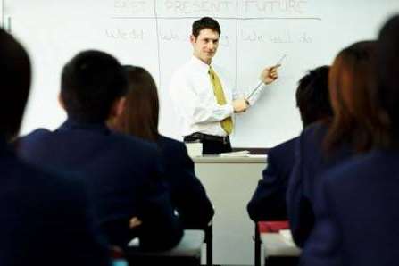 A teacher carrying out a lesson in school. Stock picture