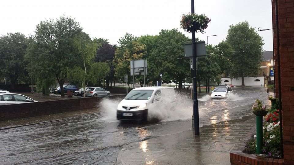 Cars battle through the water in West Street, Gravesend.