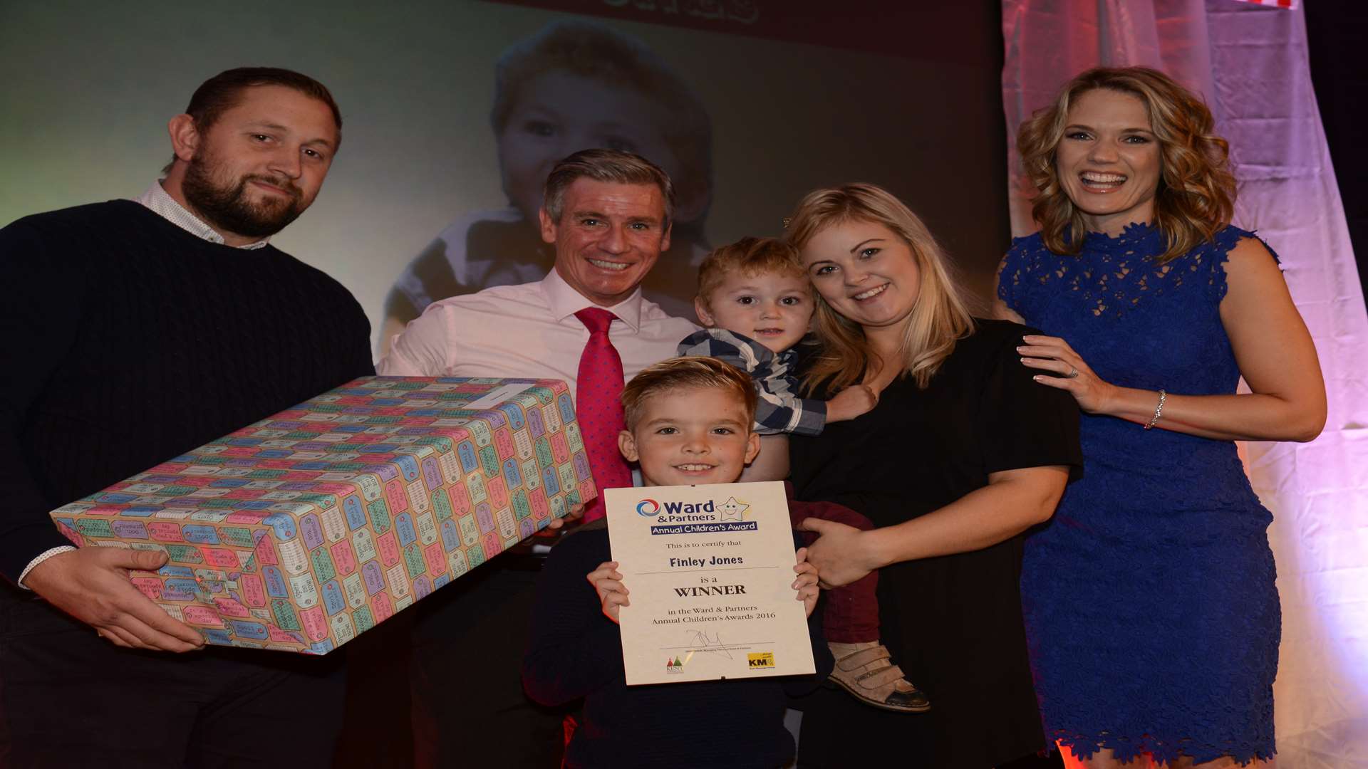 Charlotte Hawkins and financial direcor Keith Lovell present the award for Triumph over Adversity (Up to 5yrs) to Finley Jones and his family