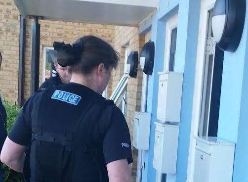 A sniffer dog enters a property during the raids