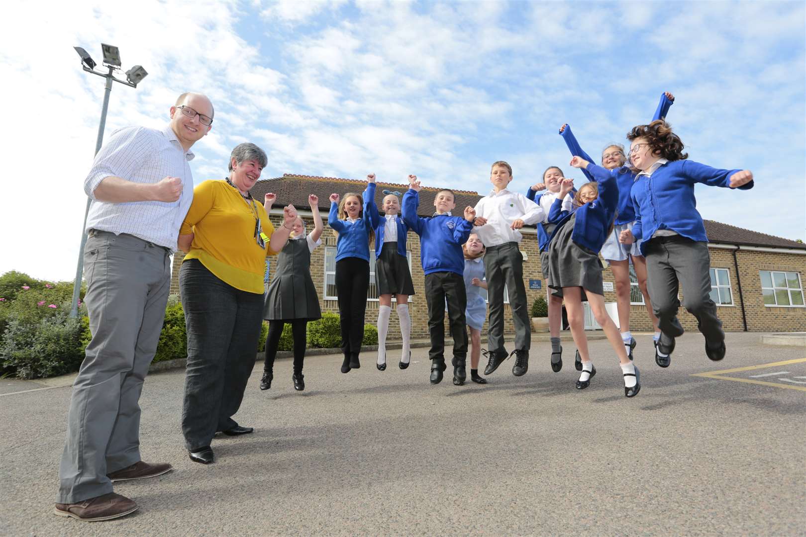 Acting head of school Simon Krafft and executive head Cathy Walker watch pupils jumping for joy after its latest Ofsted inspection