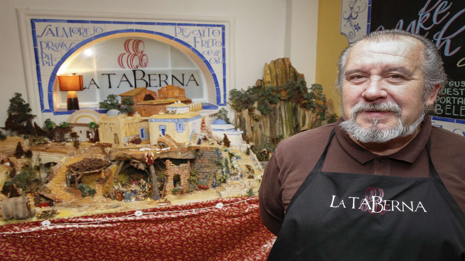 La Taberna owner Juan Munoz, pictured with the restaurant's handmade nativity scene last Christmas. Picture: Martin Apps
